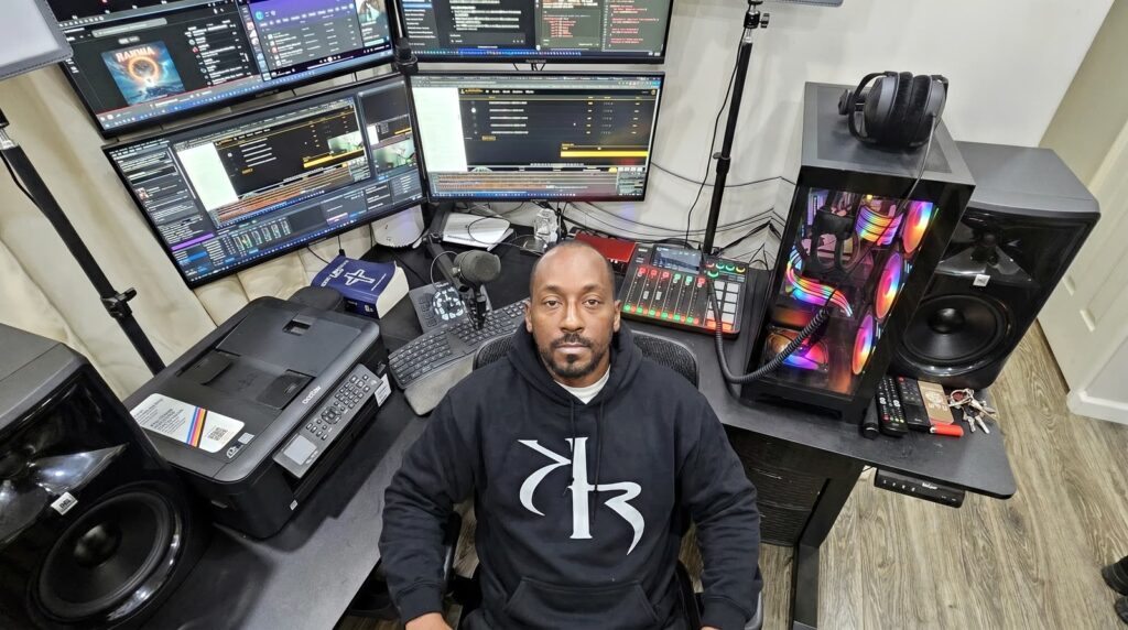Overhead view of the KR Worldwide operations desk — monitors, audio interface, and production rig.